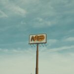 Cracker Barrel signpost with a clear blue sky background in Valdosta, GA, USA.