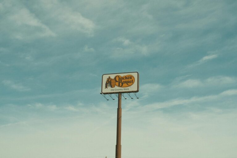 Cracker Barrel signpost with a clear blue sky background in Valdosta, GA, USA.